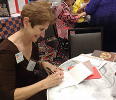 Anne Ziegler signs Christmas cards for troops overseas